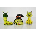 Three Lorna Bailey pottery figures: caterpillar, cat and a cat wearing a witches hat.