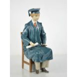 A Lladro porcelain figurine, Boy Graduate, signed to the base MC Lladro and dated 8.11.98, 28cm