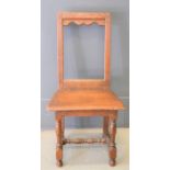 A 18th century oak child's chair with open back