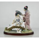 A Lladro porcelain figure group titled Springtime in Japan, 1445, geisha girls on a bridge, raised