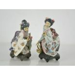 Two Lladro porcelain geisha girls picking flowers.