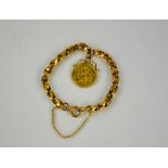 A gold full sovereign, Edward VII 1909, with mount and chain link bracelet with safety chain, 18g