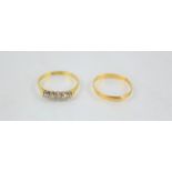 A 22ct gold wedding ring together with an 18ct gold ring set with five diamonds in a platinum