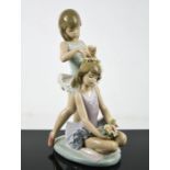 A Lladro porcelain figure group, First Ballet Ballarina's Getting Ready with Flowers, number 5714,