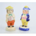 Two Victorian Staffordshire sugar sifters in the form of rotund gentlemen, both 13cm high.