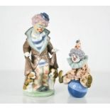 Two Lladro clowns, one with puppies 5901, and one seated on a ball 5813, 17cm high.