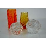 Four examples of mid century Whitefriars style glassware, two orange vases and two boulder form