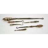 Six Victorian silver handled button hooks.