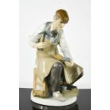 A Lladro porcelain figurine titled The Cobbler, number 4853, 25cm high.