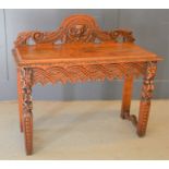 A heavily carved green man mahogany side table, 96h by 107cm by 45cm