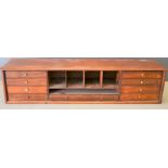 A 19th century rosewood secretaire top with pigeon holes flanked by four drawers, 25cm by 104cm by