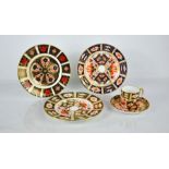 A group of Royal Crown Derby porcelain to include three plates; 1128, 2451 and 2451, and a coffee