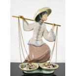 A Lladro figure of girl with scales titled Fish a Plenty, 24cm high.