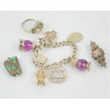 A sterling silver charm bracelet with various charms together with a Victorian silver brooch and a