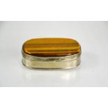 A 19th century white metal and tigers eye snuff box, 7cm long.