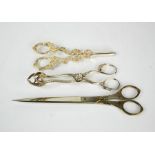 A pair of tailors scissors, a silver plated grape and vine form grape shears, and a pair of claw