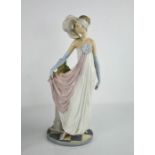 A Lladro figurine titled Socialite of the 1920s, Art Deco style lady, 34cm high.