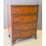 A reproduction bow fronted chest of drawers, 73cm by 55cm by 39cm