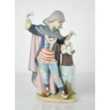 A Lladro clown, standing beside a magic hat with kittens, 5892, 28cm high.