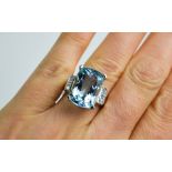 A platinum, 12ct aquamarine and diamond three stone ring, the diamonds totalling approx. 0.06ct,