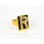 A gold (unmarked) signet ring, bearing the initial R, set with diamonds, size R/S. 7.8g.