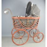 A wicker child's pram fitted with hood, liner and porcelain handles