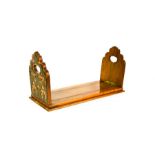 A mahogany and brass book slide, with shaped ends boards, the base 34cm long.