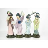 A set of four Lladro porcelain geisha girls, one holding a parasol 30cm high.