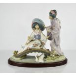 A Lladro porcelain figure group titled Springtime in Japan, 1445, geisha girls on bridge, raised