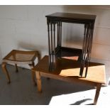 An oak coffee table together with a nest of three tables and a stool