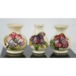 Three Moorcroft vases, two in the Magnolia pattern, one limited edition 75/94, and another in the