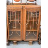 An oak display cabinet with carved front, 125cm by 90cm by 32cm