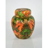 A Moorcroft ginger jar and cover in the Flames of the Forest pattern, decorated with orange and