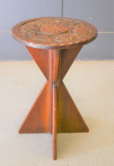 An oak table with circular carved top and shaped base, 52cm