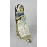 A large Lladro figurine titled Embroiderer, lady sewing, 4865, 24cm high.