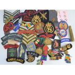 A group of WWII and later patches and buttons to include Pioneer Corps, Royal Artillery, Commandoes,