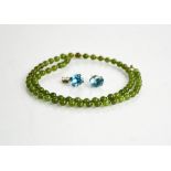 A pair of silver and cut glass earrings and a jade beaded necklace.