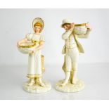 A pair of Royal Worcester figures, boy and girl holding baskets and resting against a tree stump,