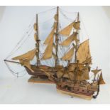 A scratch built model of a three masted sailing ship with twenty guns together with a smaller