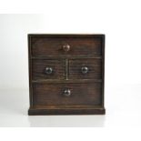 An Edwardian apprentice piece oak chest of drawers.