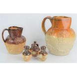 A 19th century treacle glaze pitcher and jug with relief moulded decoration of horse and hounds