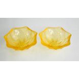 A pair of Lalique pale orange glass dishes, in the form of flower heads, etched mark to the base