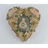 A WWI period sweetheart cushion embellished with coloured beads and embroidered panels and text on a