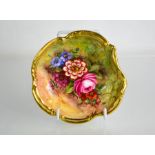 A Royal Worcester dish painted with flowers on mossy ground, signed J Freeman, date code 1935. A/F