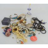 A group of vintage jewellery to include a bone carved necklace, seed pearl necklace, silver rings,