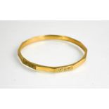 A 9ct gold bangle, engraved with chased decoration, 11g.