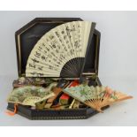 A wooden cases together with a collection of vintage fans to include lace examples