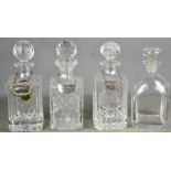 Four cut glass decanters, of various form, with three bottle tags.