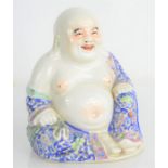 An early 20th century ceramic buddha with impressed seal mark to base, 14cm