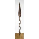 A carved tribal ceremonial paddle spear